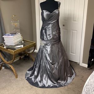 Silver One Strap Mermaid Gown With Crystal Embellishments.
